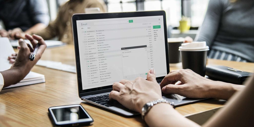 Woman checking her email in a meeting